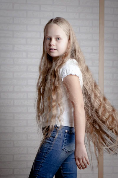 Beautiful little girl with long blonde hair — Stock Photo, Image