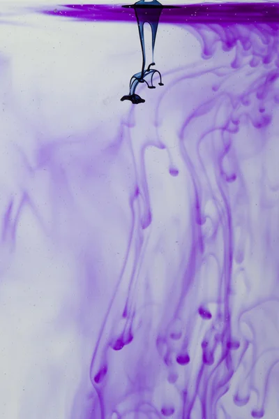 Blue and violet liquid in water making abstract forms — Stock Photo, Image