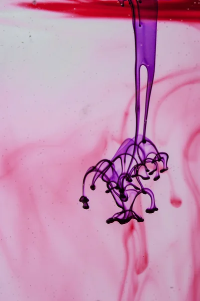 Blue and violet liquid in water making abstract forms — Stock Photo, Image