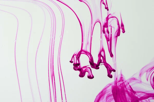 Blue and violet liquid in water making abstract forms — Stock Photo, Image