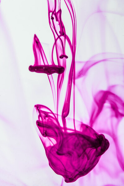 Pink inkl iquid in water making abstract forms