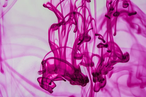 Blue and violet liquid in water making abstract forms — Stock Photo, Image