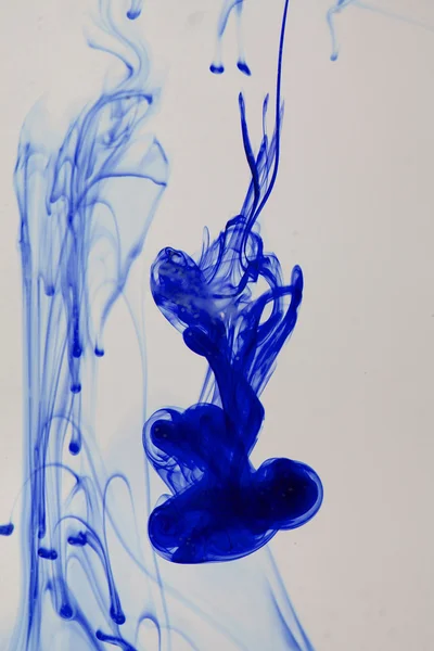 Blue and violet liquid in water making abstract forms — Stock Photo, Image