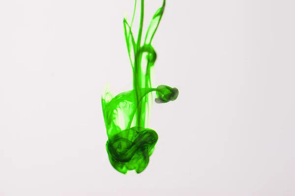 Green liquid ink in water making abstract forms — Stock Photo, Image