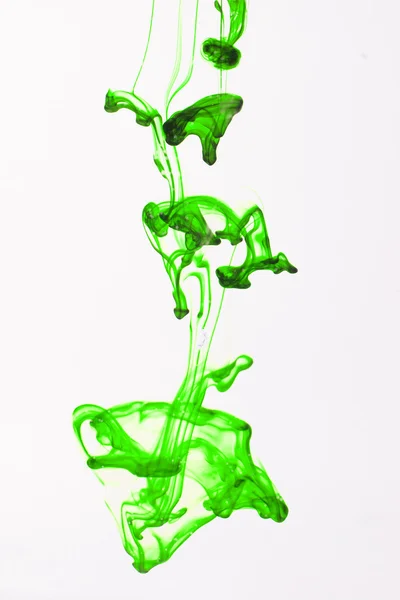 Green liquid ink in water making abstract forms — Stock Photo, Image