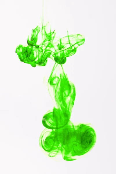 Green liquid ink in water making abstract forms — Stock Photo, Image