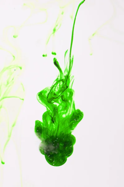 Green liquid ink in water making abstract forms — Stock Photo, Image