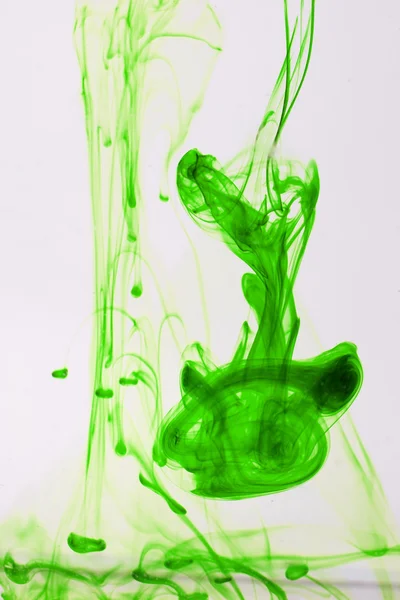 Green liquid ink in water making abstract forms — Stock Photo, Image