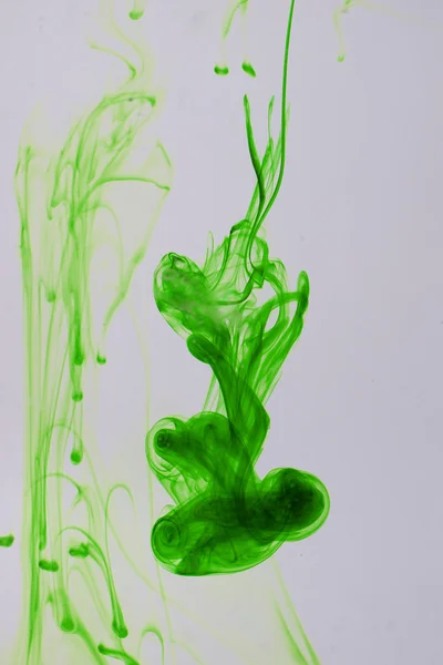 Green liquid ink in water making abstract forms — Stock Photo, Image