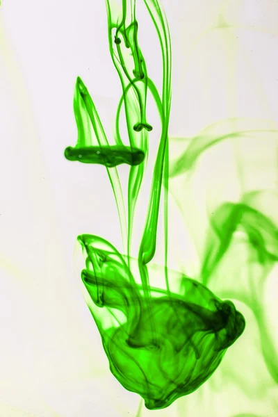 Green liquid ink in water making abstract forms — Stock Photo, Image