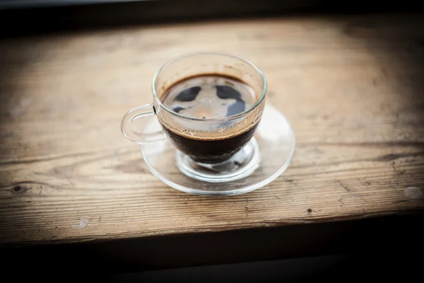 Cup of coffee on a wooden table — Stock Photo, Image