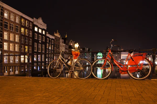 Nacht uitzicht op de stad van Amsterdam kanaal, brug, boten en fietsen, Holland, Nederland. — Stockfoto