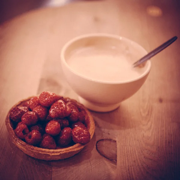 Sweet basket with cream and raspberries — Stock Photo, Image