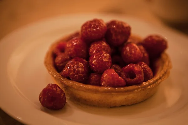 Sweet basket with cream and raspberries