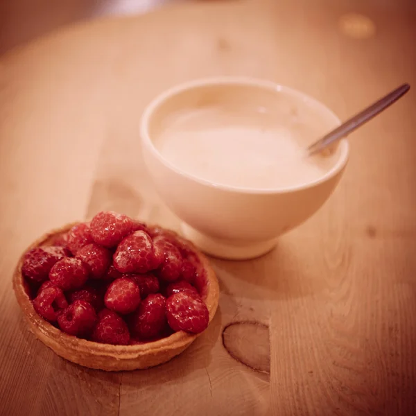 Sweet basket with cream and raspberries