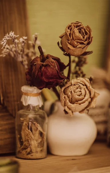 Natura morta in stile vintage con tre rose secche e bottiglia — Foto Stock