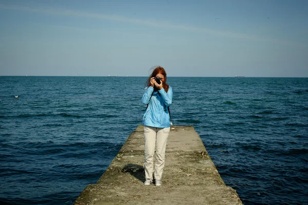 Back view of a woman taking picture — Stock Photo, Image