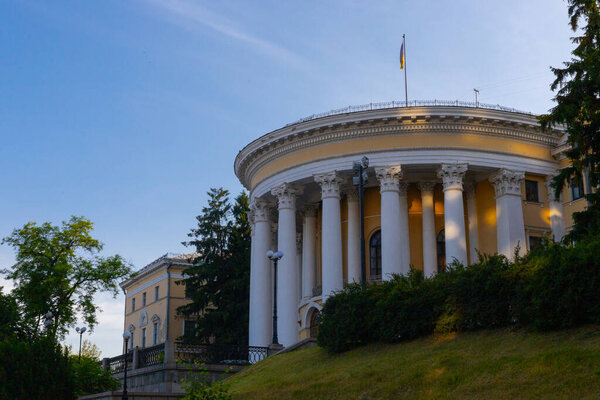 Kyiv, Ukraine - 12 June 2025: Front exterior view of the  October (Zhovten) palace  , International Center of Culture and Arts, featuring classical architecture and a national flag atop