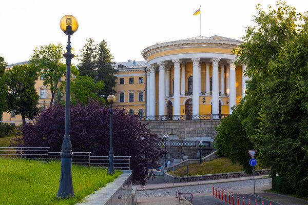 Kyiv, Ukraine - 12 June 2025: Front exterior view of the  October (Zhovten) palace  , International Center of Culture and Arts, featuring classical architecture and a national flag atop