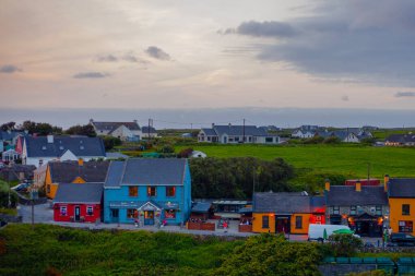 Doolin, İrlanda - 3 Ağustos 2025: Clare İrlanda 'da geleneksel renkli kulübelerle eski Doolin köyünün panoramik manzarası. 