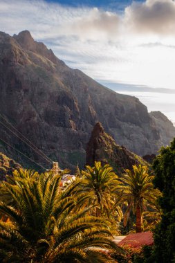 Tenerife 'deki Masca Vadisi' nin manzarası, Kanarya Adası, İspanya. Tenerife 'de palmiye ağaçları ve tropikal bitki örtüsü olan manzaralı bir dağ manzarası. Masca köyünde ünlü volkanik kaya oluşumu