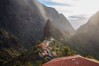 Tenerife 'deki Masca Vadisi' nin manzarası, Kanarya Adası, İspanya. Tenerife 'de palmiye ağaçları ve tropikal bitki örtüsü olan manzaralı bir dağ manzarası. Masca köyünde ünlü volkanik kaya oluşumu