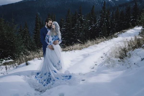 Krásná nevěsta a ženich v zimě sníh na horských — Stock fotografie