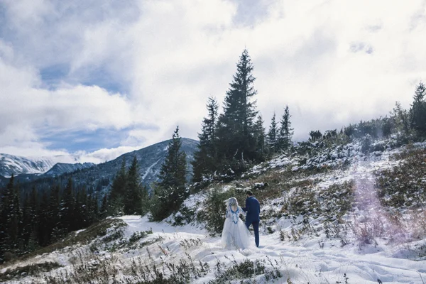 Belle mariée et marié dans la neige d'hiver sur la montagne — Photo