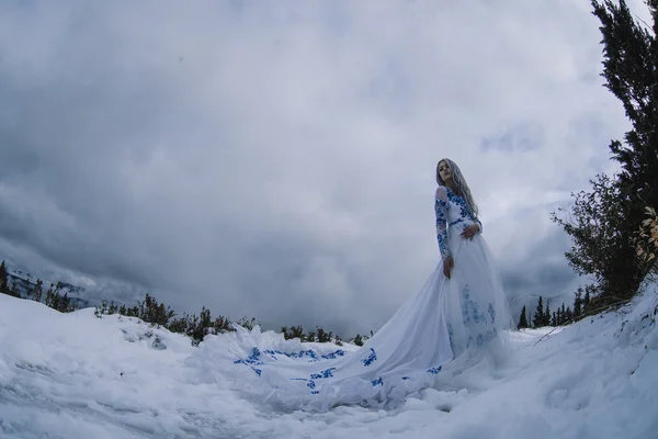 Hermosa novia en montañas de nieve — Foto de Stock