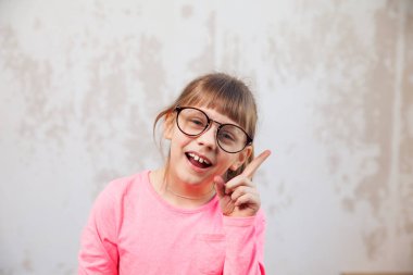   8 yaşında, arka planda gözlüklü bir kız..