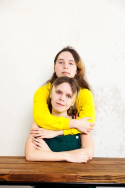 Işıl ışıl iç mekanlarda 14 yaşındaki iki ikiz kızın portresi.