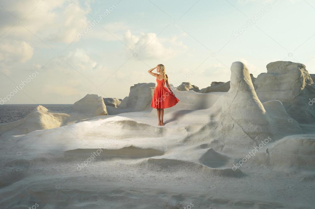 Lady in red dress in an unusual landscape