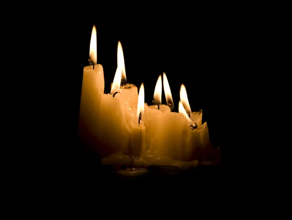 Group of white candles burning in the dark — Stock Photo, Image