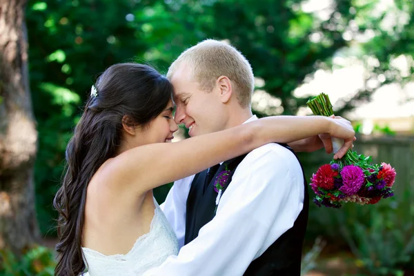 Kaukasiska brudgummen håller sin biracial brud, leende. Olika cou — Stockfoto