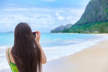Güzel genç kız Hawaii holding kamera resim çekme