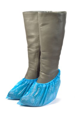 Women's leather boots in shoe covers. clipart