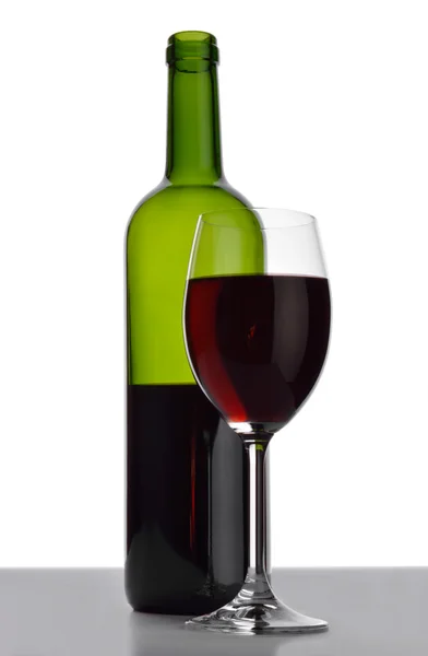 Bottle and wineglass with red wine. — Stock Photo, Image
