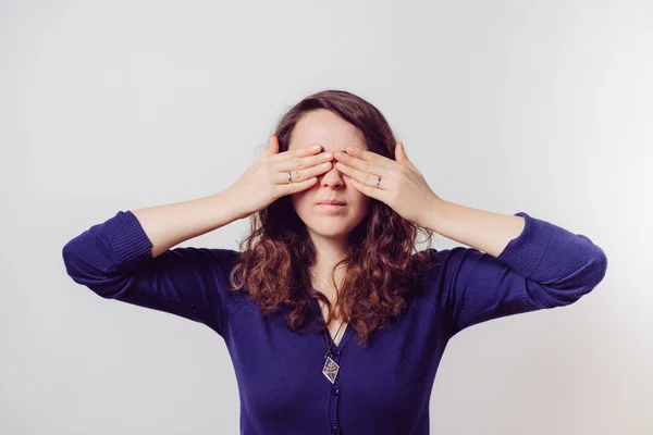 Woman closes eyes with her hands — Stock Photo, Image