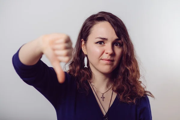 Woman showing a thumb down gesture — Stock Photo, Image