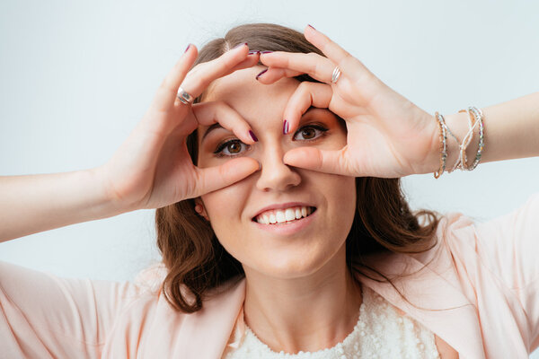 girl shows hands binocular