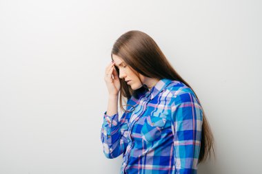 Baş ağrısı olan genç bir kadın.