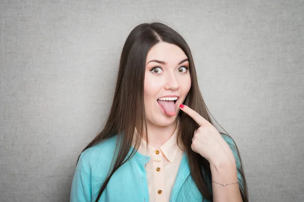 Girl sticking her tongue out — Stock Photo, Image