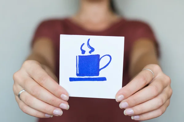 Иконка чашки кофе в руке — стоковое фото