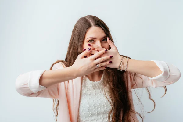 Girl covers mouth with hands — Stock Photo, Image