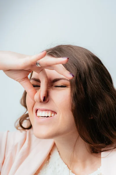 Girl pinch her nose — Stock Photo, Image