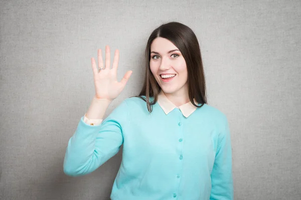 Junge Frau winkt — Stockfoto