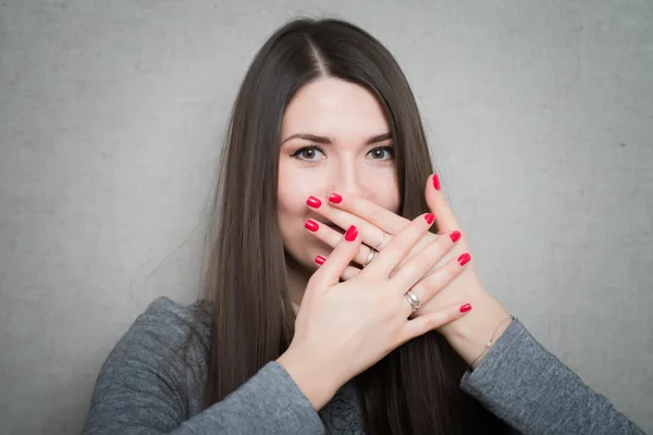 Girl covering mouth with hands — Stock Photo, Image