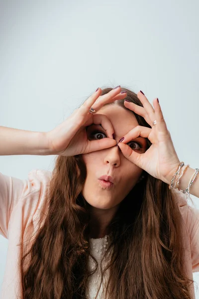 girl shows hands binocular