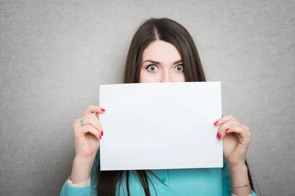 Girl holding white blank paper — Stock Photo, Image