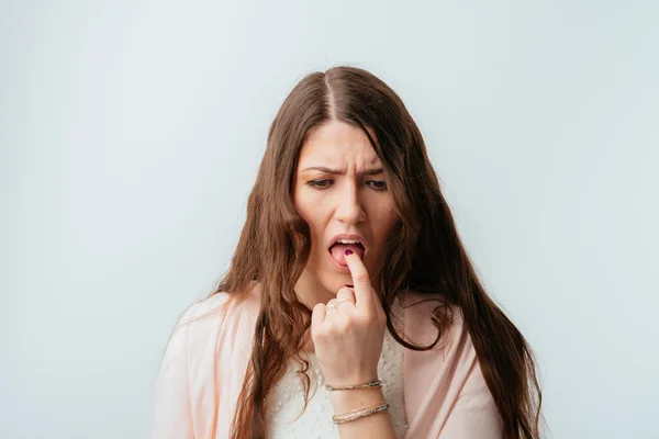 Girl shows a finger on the tongue — Stock Photo, Image